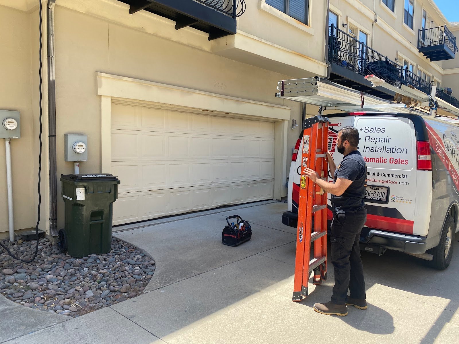 Technician inspecting a residential garage door